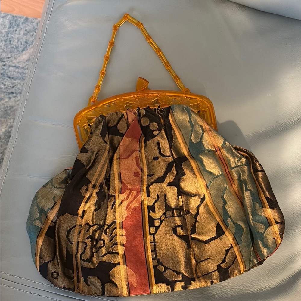Fabric purse with plastic hinged opening it looks vintage